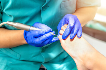 Female podiatrist doing chiropody in her podiatry clinic. Selective focus