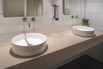 Interior of bathroom with washbasin and faucet. Public bathroom in the airport or restaurant, cafe, office. Bathroom interior sink with modern design in hotel