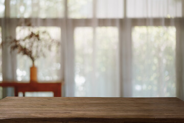 Abstract room with a window in the morning blurred background with wood table.