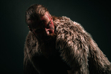 Viking warrior with war paint and fur in battle meditation