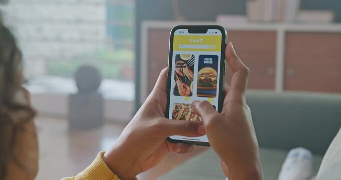 Woman On Sofa Looking At Her Cellphone. Woman Searching What Meal Buy For Dinner Or Lunch. Person Scrolling Through Online Food Menu On Smartphone Application