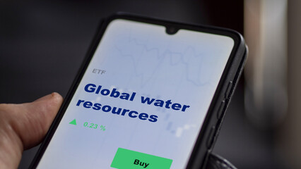 An investor's analyzing the  on screen. A phone shows the ETF's prices global water resources.