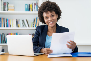 Laughing african american business trainee at work