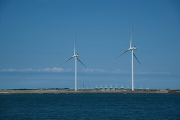 View of Neeltje Jans flood barrier with wind turbines