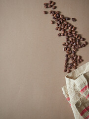 coffee beans emerging from a burlap sack. Flat lay with copy space