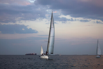 Plakat Sailing yacht regatta. Sailboats under sail in the race. Yachting. Luxury yachts.