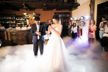 Beautiful wedding couple just married and dancing their first dance