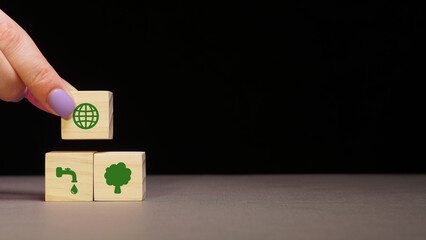 The concept of environmental protection. concrete cube with green economy icons, energy sources. copy space. green energy