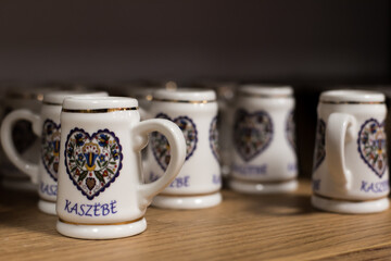 Small cups, a souvenir from the Kashubian region in Poland. - obrazy, fototapety, plakaty