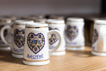 Small beer mugs with folklore symbols, a souvenir from Kashubia. - obrazy, fototapety, plakaty