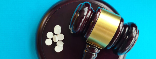 Judge gavel and pills. Litigation related to pharmaceuticals and law in medicine