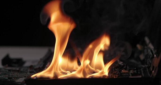 Burning laptop computer electronics closeup
