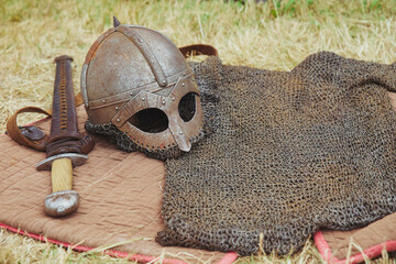 Old Viking armor on yellowed grass. Viking Festival 