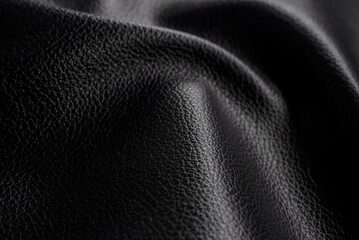Black leather texture. Abstract background of dark leather with small roughness and scuffs