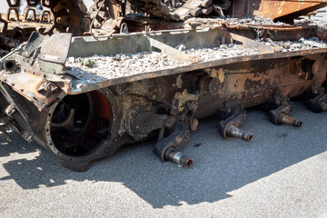 Fragment of a destroyed Russian military tank during the war in Ukraine. Chassis without wheels.