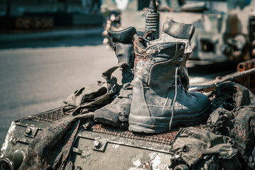 Fragments of burnt shoes and clothes of Russian soldiers on wrecked armored vehicles in the war in...