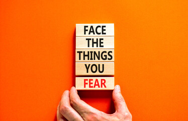 Face the things you fear symbol. Concept words Face the things you fear on wooden blocks on a...