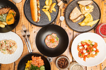Spanish and Latin American food tapas, strips of eggplant with hummus and cane syrup, loin and cheese toasts, assorted croquettes, Colombian corn empanadas, ribs with French fries and padrón peppers