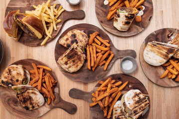 Lots of Spanish sandwiches with assorted fillings, brioche bun burgers, tarts and chips and sweet potato fries