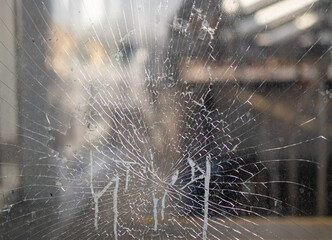 Showcase with broken glass during a protest in a city with protesters.