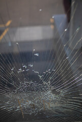 Showcase with broken glass during a protest in a city with protesters.