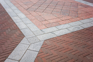 Fototapeta premium street pavement made of stone tiles lined