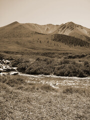 Vintage misty landscape with hills and rocks  in sepia tones.