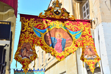 Street view with colorful flag decorations in old city of Valletta, Malta