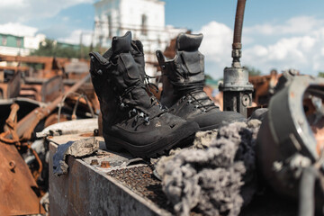 Boots of a Russian soldier on a destroyed tank in the center of Kyiv - obrazy, fototapety, plakaty