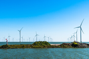 Wind turbines in the IJsselmeer not far from the beach