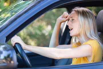 side view window portrait displeased stressed angry woman driving car