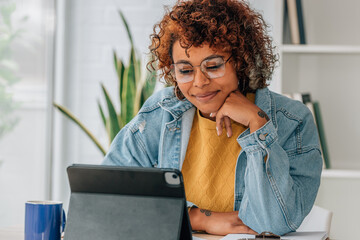smiling latina african american girl at home with laptop