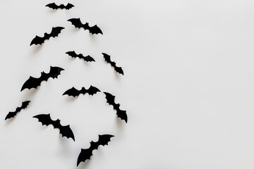 Bat silhouettes on the white wall with copy space.