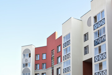 The stylish facade of a residential building with beautiful windows is a new multi-apartment residential quarter of European houses.