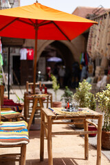 Bar terrace in an empty street in Marrakesh, Morocco on a hot summer sunny day