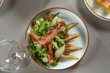 Salad with pear, bacon and walnuts. Haute cuisine, beautiful service.