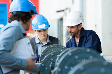 close up of engineers assembling machinery parts
