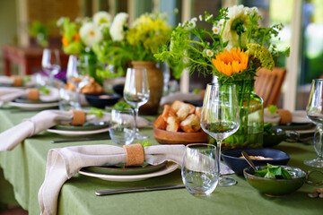 beautiful setting of a large table with flowers. 
