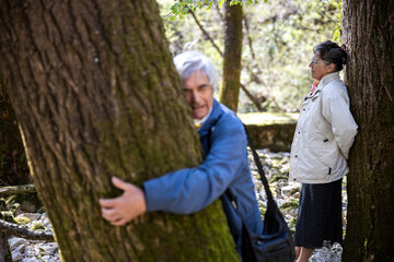 Senior Couple Enjoying the Energy Vibration of Trees