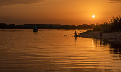 Beautiful bright dramatic sunset over the river