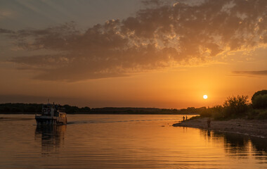Beautiful bright dramatic sunset over the river