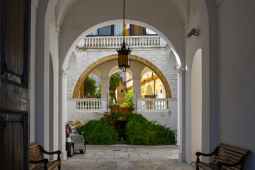 A picturesque courtyard with a grotto and Virgin Mary statue in the town of Brindisi, Italy
