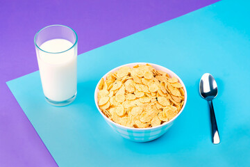 Plate of whole grain cereal with a glass of fresh milk for breakfast.