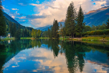 Fototapeta na wymiar Chamonix, France. Beautiful Lake Gaillands (Lac des Gaillands), in Chamonix valley, French Alps. The lake reflected mountains and sky. Fantastic sunset. 