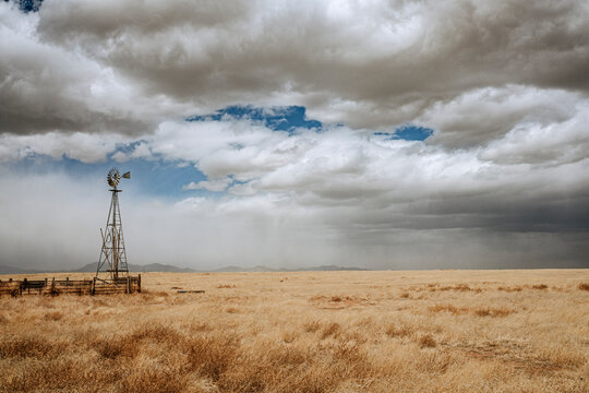 Agricultural wind mill and passing thunderstorm, tucumcari, New Mexico
