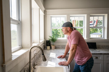 Marine veteran at home with family on a early morning in the kitchen.