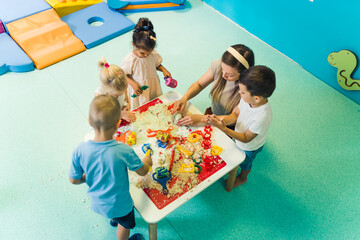kids enjoying with kinetic sand at the nursery. High quality photo