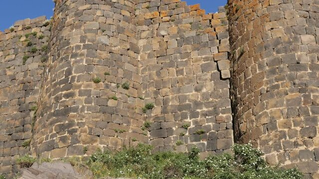 a look at the ancient walls and towers of a stone fortress that has survived to our era. Ancient monument of history and architecture Armenian fortress Amberd against the blue sky