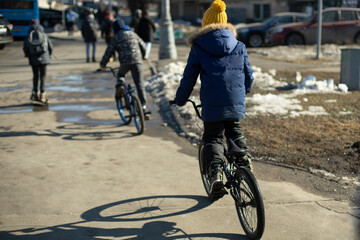 Child on bicycle. Child ride around town.