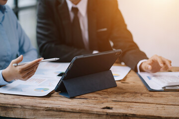 Group of business people meeting together Pointing to the graph assess business profits